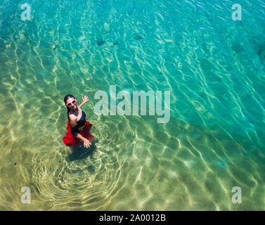 Aerial view of a beautiful woman dancing  in the sea