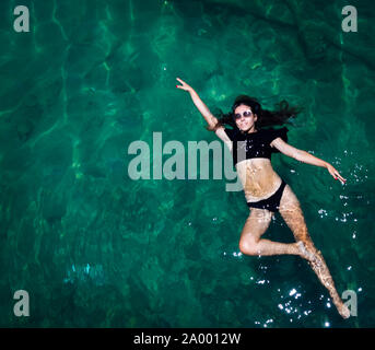 Aerial view of a woman relaxing in the sea