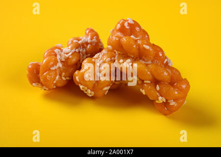 traditional Chinese twisted deep fried doughs on yellow background Stock Photo