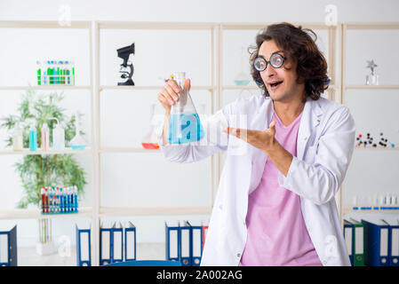 The funny male chemist working in the lab Stock Photo
