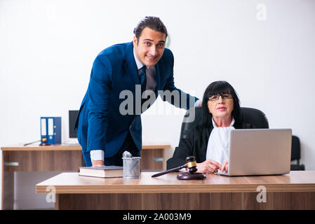 The female judge and her assistant in the courthouse Stock Photo