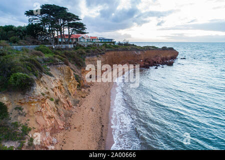 Large house on a cliff over ocean at sunset in Australia Stock Photo