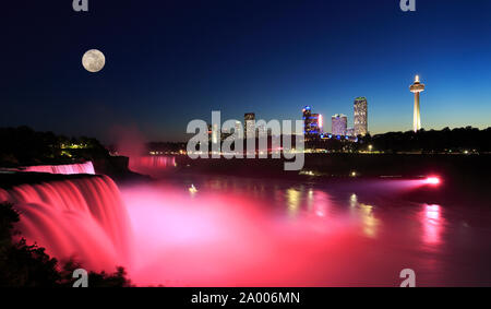 Niagara Falls at dusk including the moon and skyline of the Canadian city on the background Stock Photo