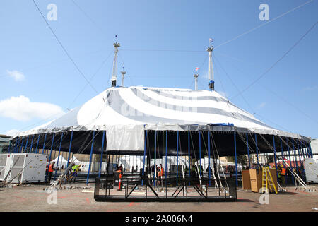 Sydney, Australia. 19th September 2019. Cirque du Soleil’s brand new white and grey Big Top was raised to mark the arrival of KURIOS – Cabinet of Curiosities.  Media photographers and reporters were invited to witness the raising of the Big Top and set-up of the travelling Cirque du Soleil village. Over 60 technicians raised more than 100 metal poles in the final step of building the roof of the “grand chapiteau”. The Big Top stands about 20 metres (56 feet) high and is 51 metres (164 feet) in diameter. Credit: Richard Milnes/Alamy Live News Stock Photo
