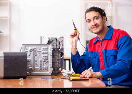 The young engineer repairing musical hi-fi system Stock Photo