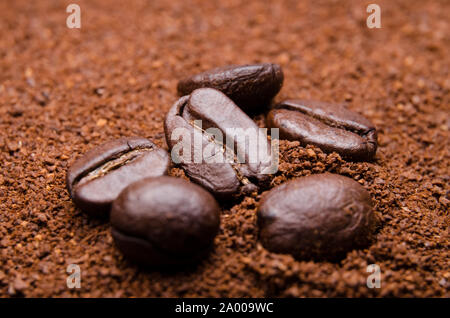 Close-up of roasted espresso coffee beans on ground coffee Stock Photo