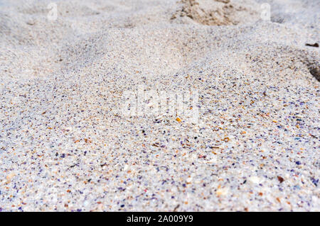 Beautiful white sand texture with small blue pieces of shellfish. Sand dunes. Summer sand background texture. White sand of Jervis Bay, Australia. Sel Stock Photo