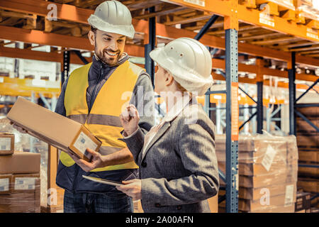 Pretty manager talking to her positive worker Stock Photo