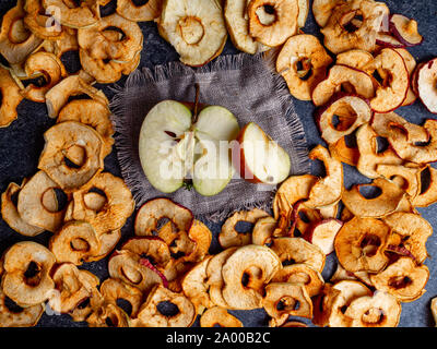 fresh applewith pieces of dry in dehydrator slices of yellow and red apples, healthy snack concept Stock Photo