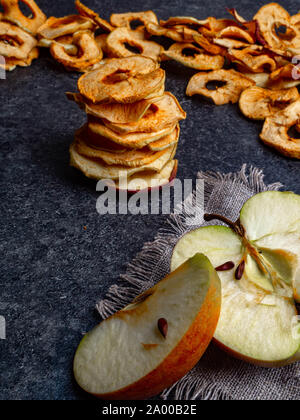 fresh applewith pieces of dry in dehydrator slices of yellow and red apples, healthy snack concept Stock Photo