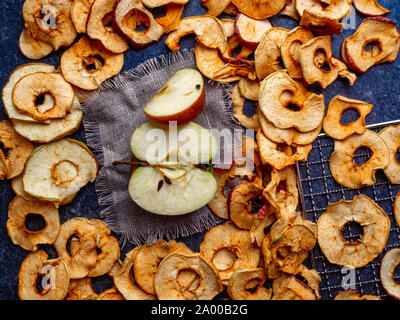 fresh applewith pieces of dry in dehydrator slices of yellow and red apples, healthy snack concept Stock Photo