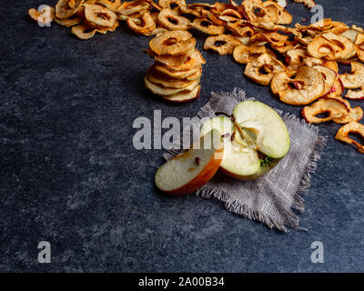 fresh applewith pieces of dry in dehydrator slices of yellow and red apples, healthy snack concept Stock Photo
