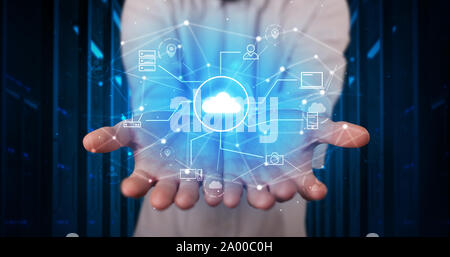Man holding hologram projection displaying cloud technology symbols Stock Photo