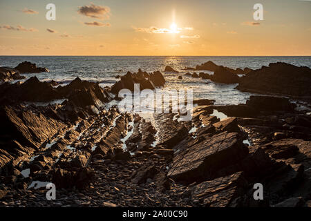 Sunset over the Atlantic ocean at Hartland Quay, Devon, England Stock Photo