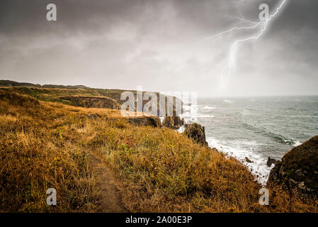 Lightning bolt strike from a thunderstorm near the cliffs of Pointe Saint Mathieu, Brittany, France Stock Photo