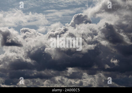 Dramatic clouds in the blue sky on a sunny September day Stock Photo