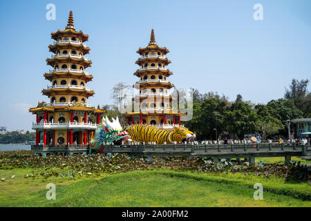 Kaohsiung, Taiwan: Tiger and Dragon Pagodas with green grass and Lotus in the front. Located at Lotus Pond in Zuoying district, Kaohsiung Stock Photo