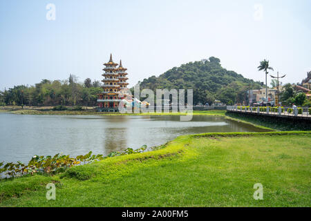 Kaohsiung, Taiwan: Tiger and Dragon Pagodas with green grass and Lotus in the front. Located at Lotus Pond in Zuoying district, Kaohsiung Stock Photo