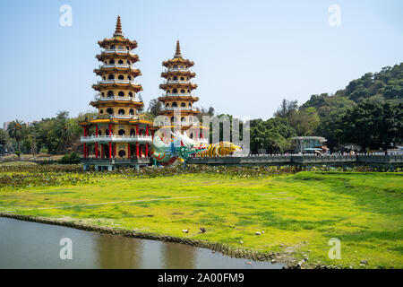 Kaohsiung, Taiwan: Tiger and Dragon Pagodas with green grass and Lotus in the front. Located at Lotus Pond in Zuoying district, Kaohsiung Stock Photo