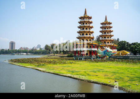 Kaohsiung, Taiwan: Tiger and Dragon Pagodas with green grass and Lotus in the front. Located at Lotus Pond in Zuoying district, Kaohsiung Stock Photo