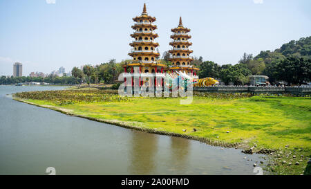 Kaohsiung, Taiwan: Tiger and Dragon Pagodas with green grass and Lotus in the front. Located at Lotus Pond in Zuoying district, Kaohsiung Stock Photo