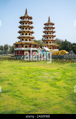 Kaohsiung, Taiwan: Tiger and Dragon Pagodas with green grass and Lotus in the front. Located at Lotus Pond in Zuoying district, Kaohsiung Stock Photo