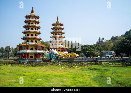 Kaohsiung, Taiwan: Tiger and Dragon Pagodas with green grass and Lotus in the front. Located at Lotus Pond in Zuoying district, Kaohsiung Stock Photo