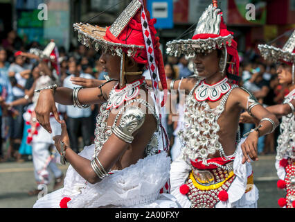 Kandyan Dancers, otherwise known as Up Country Dancers, perform along a street during the Buddhist Day Perahera at Kandy in Sri Lanka. Stock Photo