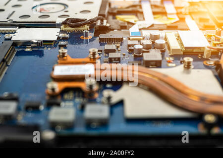 Technician repairing broken laptop notebook computer with screwdriver Stock Photo