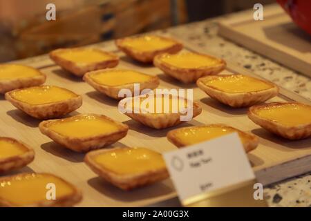 Tong Heng's egg tarts, popular diamond-shaped egg tart in Singapore, on display at the store window in its Chinatown store. Stock Photo