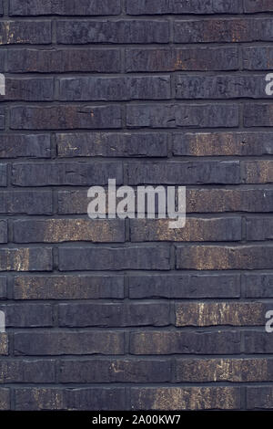 Horizontal black bricks background. A part of wall of the building Stock Photo