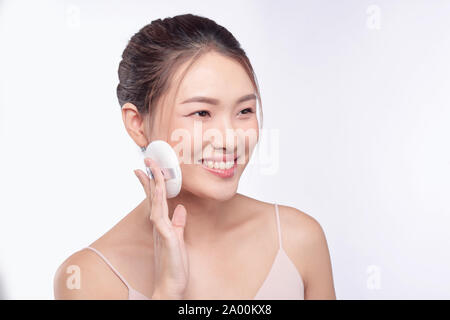 face of beauty young woman applying sponge - isolated on white Stock Photo