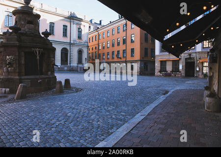 Lighting under awning at dawn in Stortorget the medieval square at the heart of Gamla Stan, Stockholm's old town, Stockholm, Sweden Stock Photo