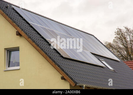 Solar collectors on a pitched roof for clean electricity in the private household Stock Photo