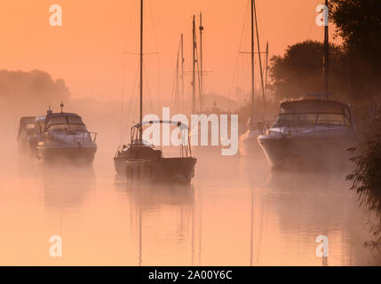 Wareham, Dorset, UK. 19th September 2019. UK Weather:  A tranquil scene at Wareham as boats moored along the River Frome are shrouded in soft mist at the start of another beautiful sunny autumnal morning. Credit: Celia McMahon/Alamy Live News. Stock Photo