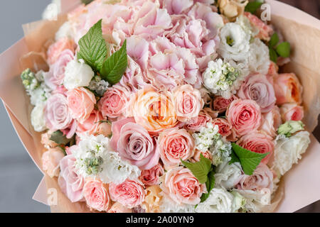 Large beautiful bouquet of mixed flowers in woman hand. Floral shop concept . Handsome fresh bouquet. Flowers delivery. Stock Photo
