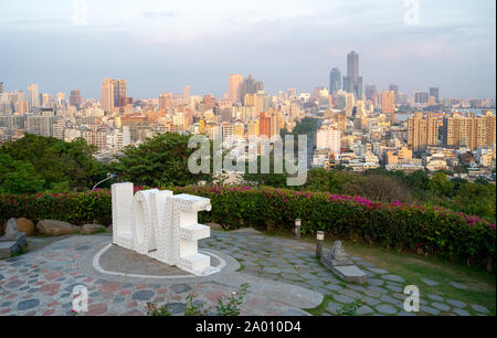 Kaohsiung, Taiwan: The word Love in giant letters with glowing lights in front of the Kaohsiung Skyline at Martyrs Shrine Stock Photo