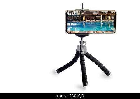 Smartphone and smartphone tripod on white background. Stock Photo