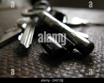 Macro Shot of Old Key on a Key Chain with shallow depth of field - selective focus / background, texture Stock Photo