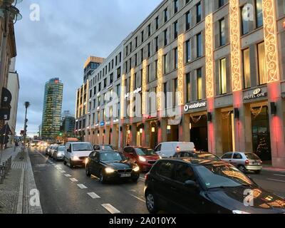 Berlin, Germany - December 10, 2018: Shopping Mall of Berlin Exterior with Christmas Decoration, Christmas Tree and Lights and Potsdamer Platz in Back Stock Photo