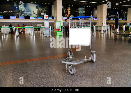Empty airport trolley with a blank advertising space. Stock Photo