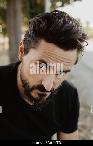 Portrait of a bearded young man standing outdoors in the nature Stock Photo