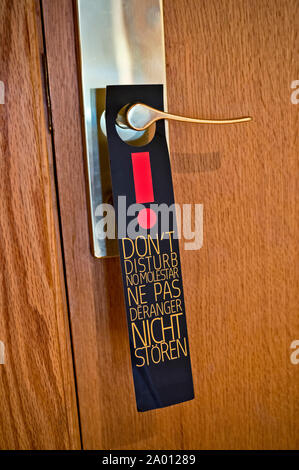 A sign saying 'Do not disturb' hangs on the door in a hotel Stock Photo