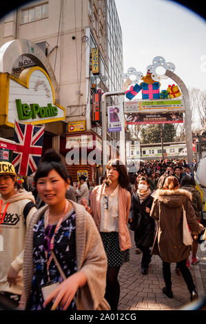 With a vast public transportation network, Tokyo residents leave a rail station toward the city center in Japan. Stock Photo