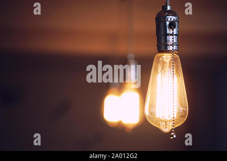 Lamps with tungsten filament. Edison's light bulb. Filament filament in vintage lamps. Retro design of light bulbs. Stock Photo