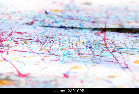 multiple colored action painting. paint splattered in drips and lines all over a white canvas background. splashed paint pattern. Stock Photo