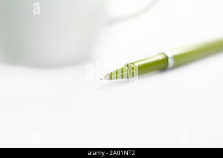 Picture of Green Pen with cup. Isolated on white background. Stock Photo