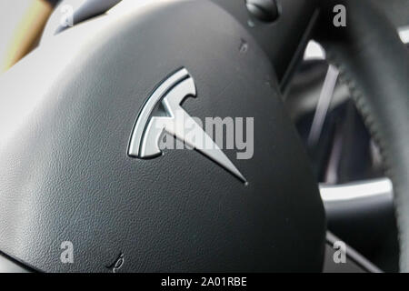 Seattle,WA/USA-9/15/29: A Tesla Car Emblem on a steering wheel.  Tesla, Inc. is an American automotive and energy company that specializes in electric Stock Photo