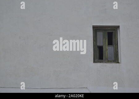 broken window on white wall Stock Photo