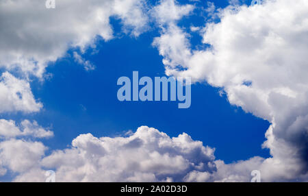 Blue sky gap between cumulus clouds Stock Photo